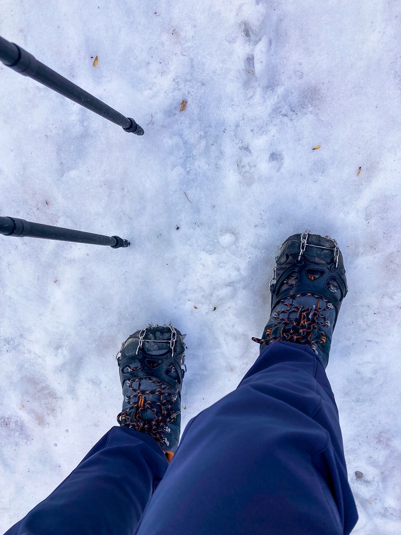 Basic crampons below shoes while hiking in snow