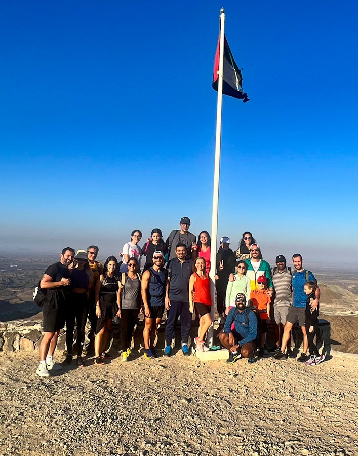 Group photo with UAE Flag at the top of stairs