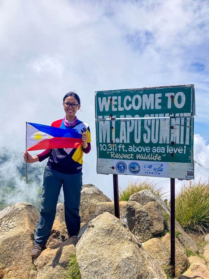 PinayHakawati at Mount Apo Kidapawan Summit holding a Philippine Flag