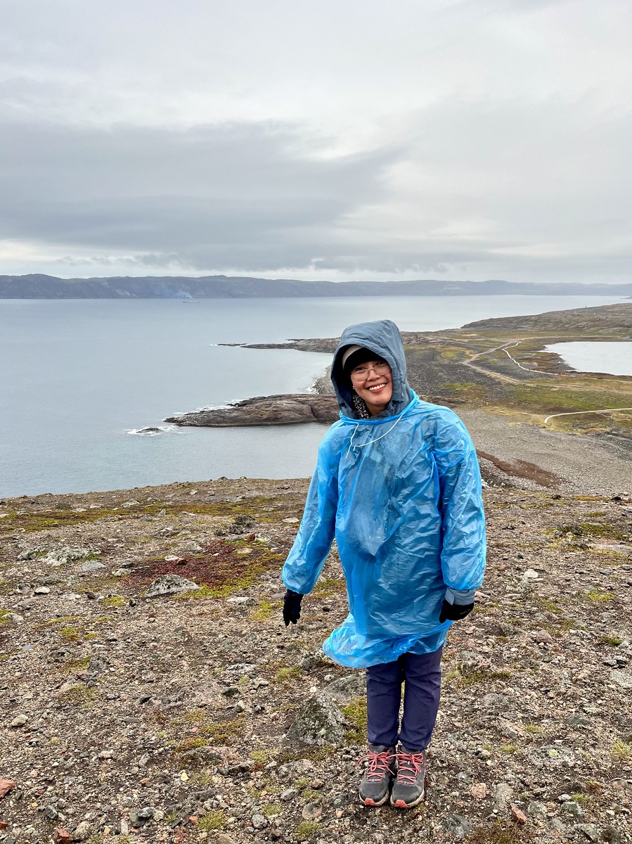 Posing for a photo in Teriberka with Barents Sea at the background during tour in Russia in September 2024