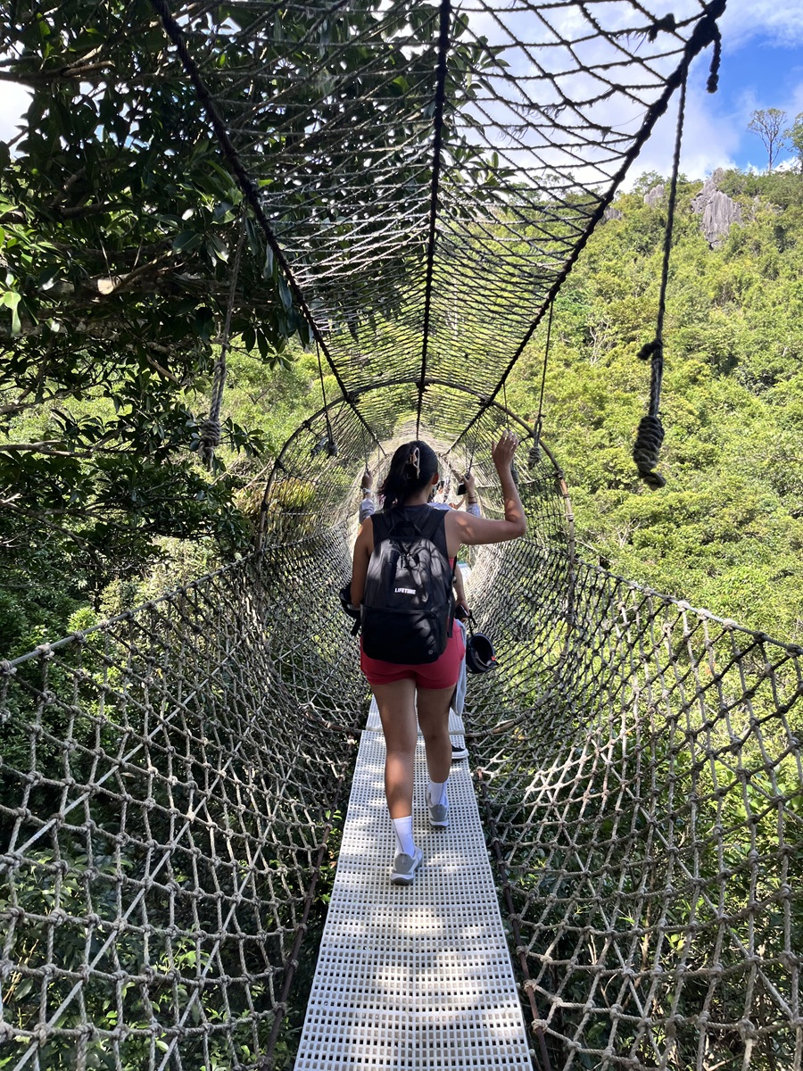 Crossing hanging bridge during hike in Masungi Georeserve via Discovery Trail